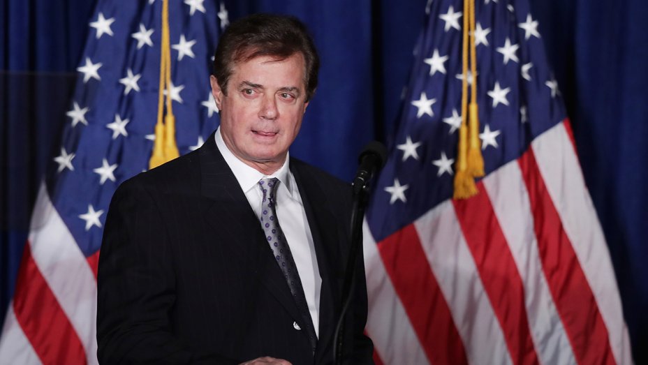 Paul Manafort standing in front of the American flag.