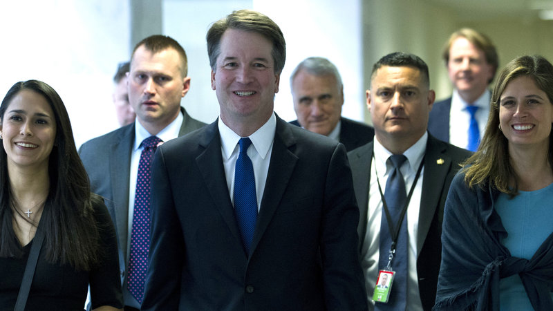 Brett Kavanaugh walking surrounded by aides